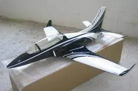 A black and white model airplane sitting on top of a floor.