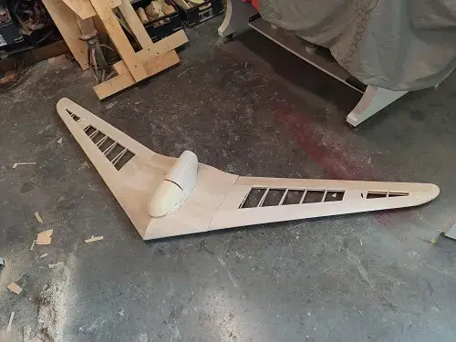 A wooden plane sitting on top of the floor.