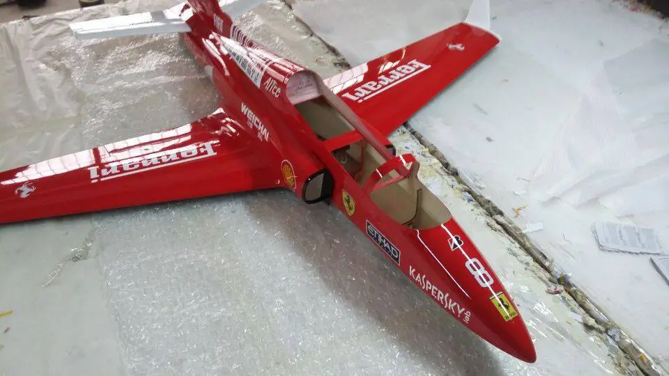 A red jet fighter plane with cardboard wings.