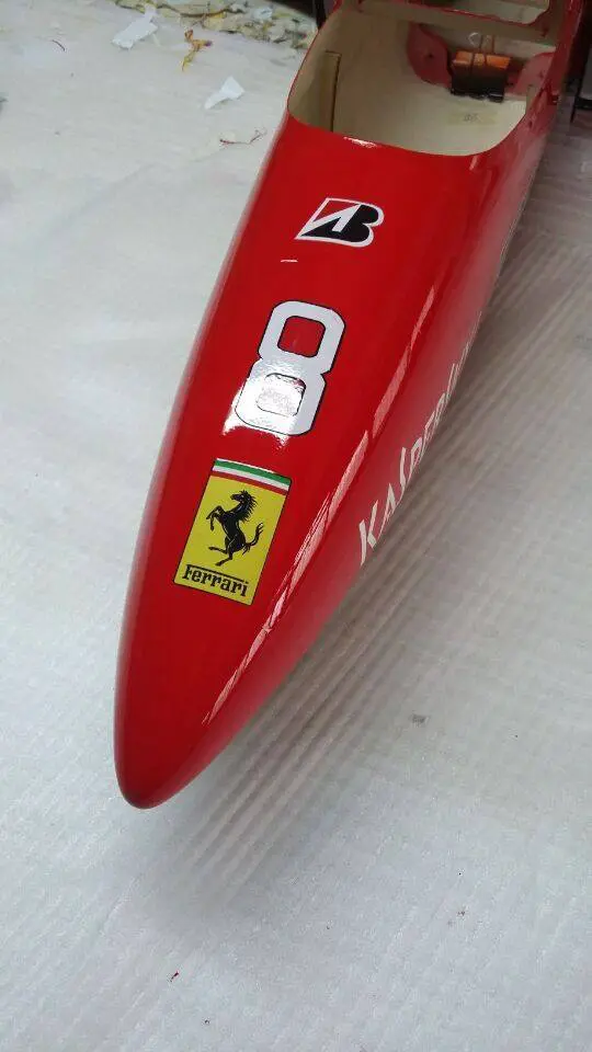 A close up of the side of a red ferrari
