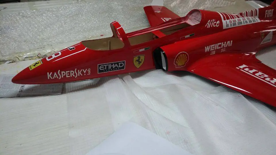 A red toy jet car with the name " supersky !" on it.