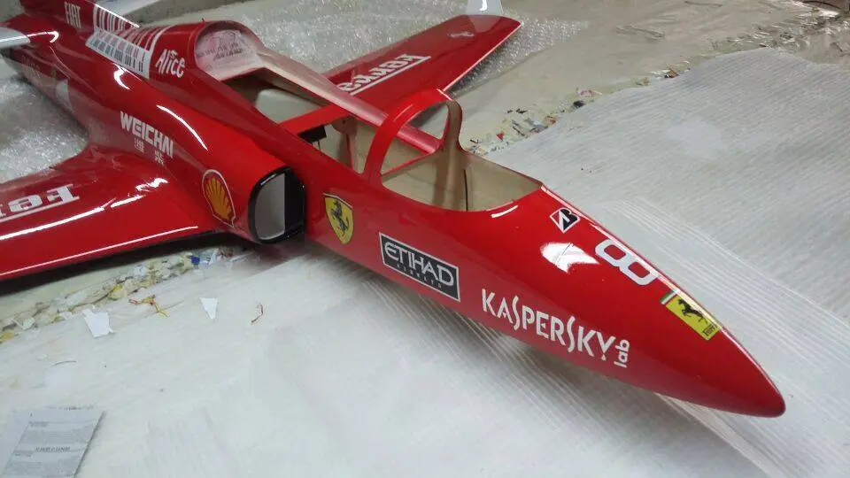 A red toy plane sitting on top of a table.
