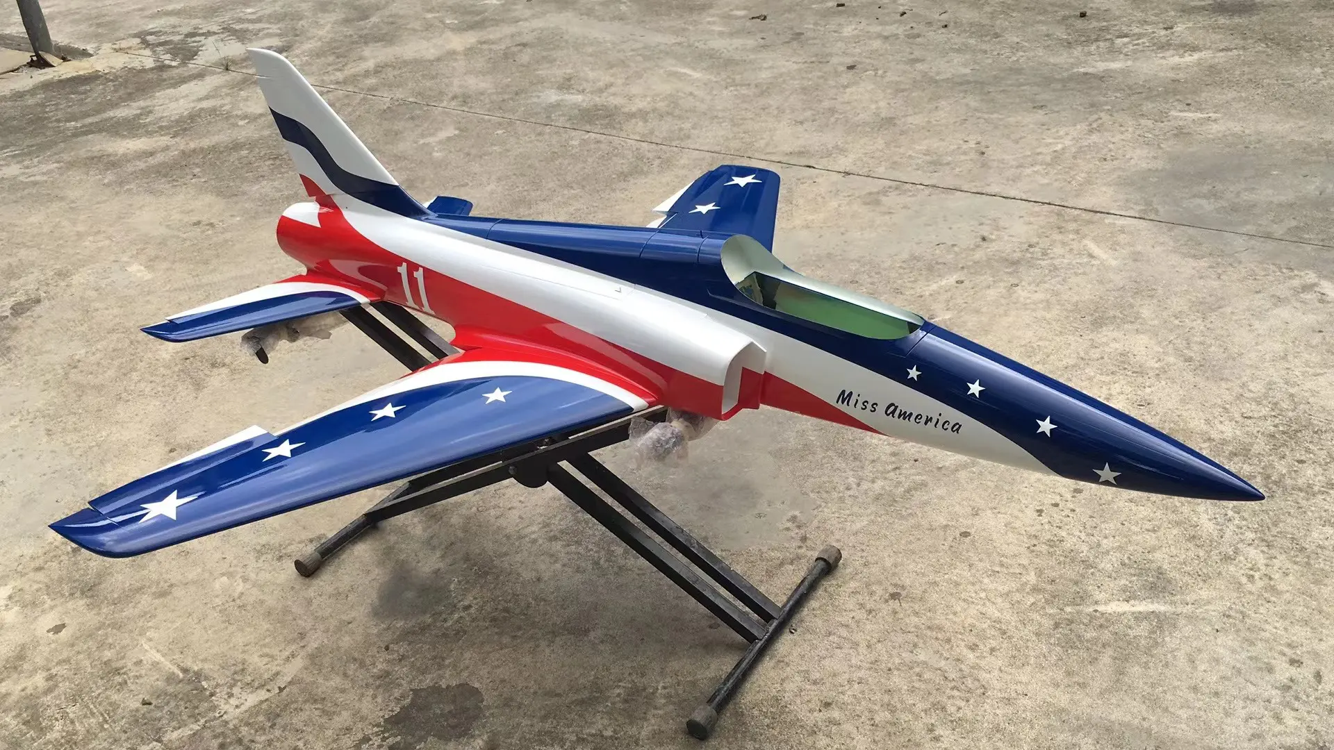 A red, white and blue jet fighter plane on display.