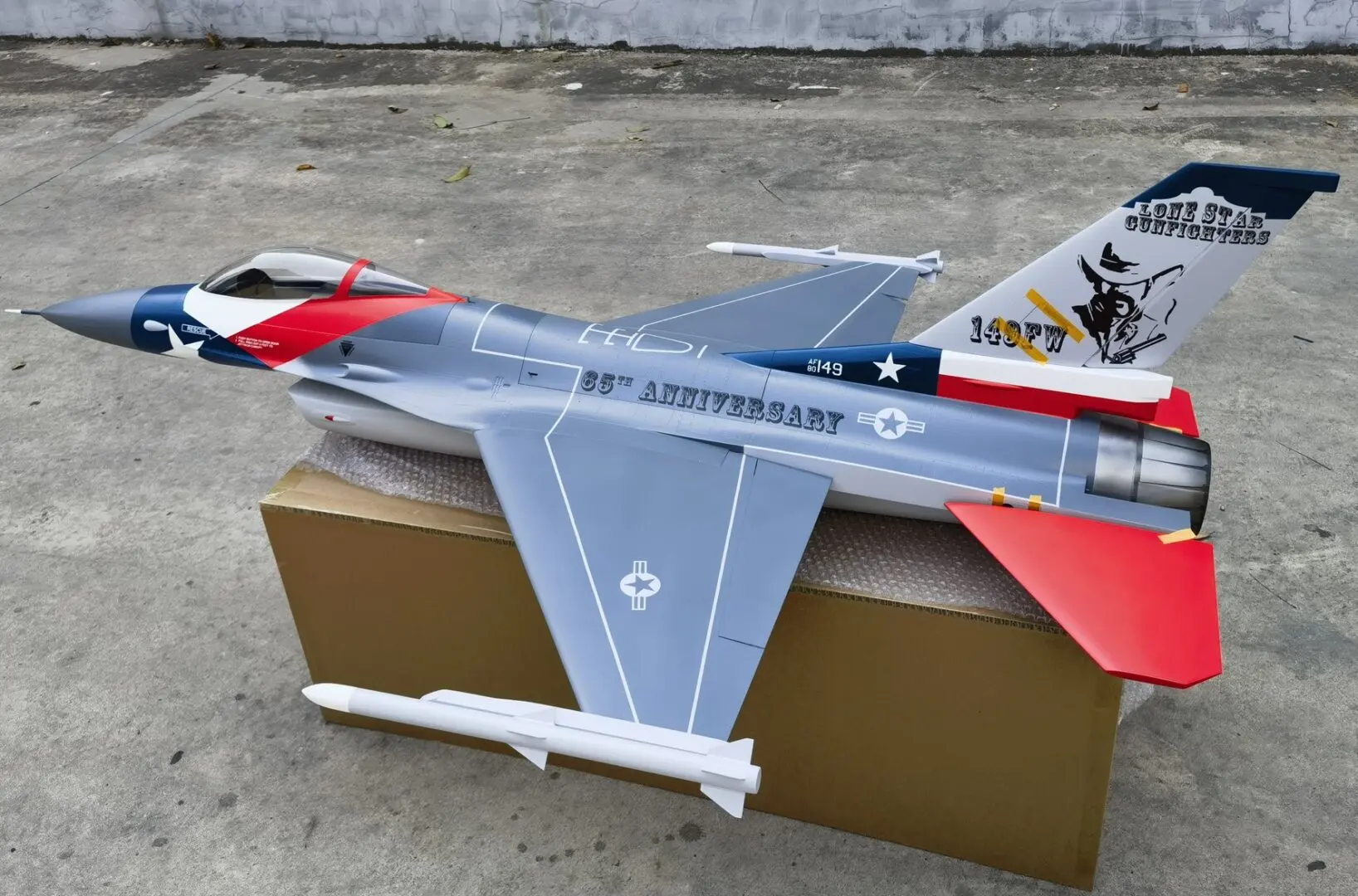 A model of an airplane sitting on top of a box.