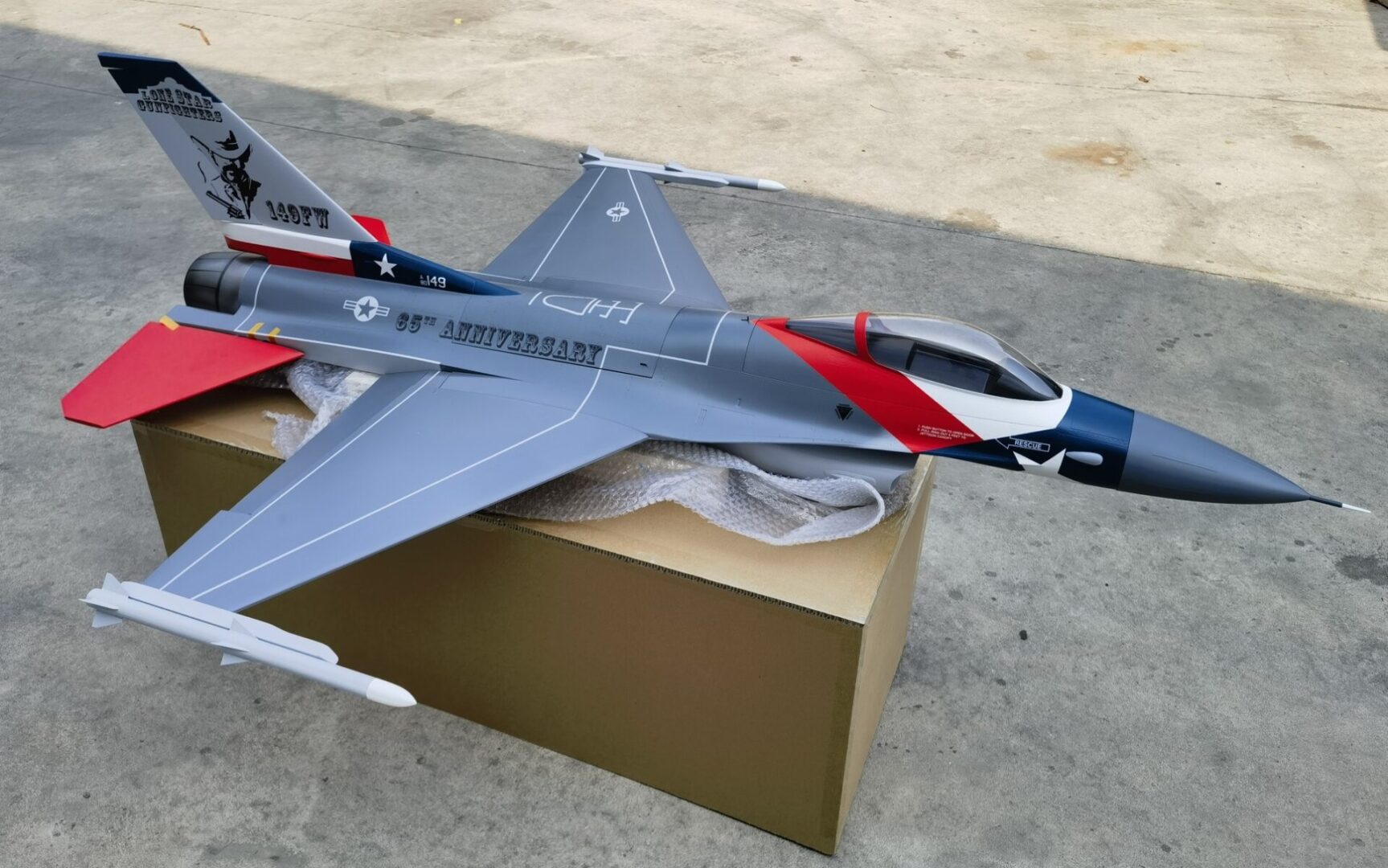 A model jet is sitting on top of a box.
