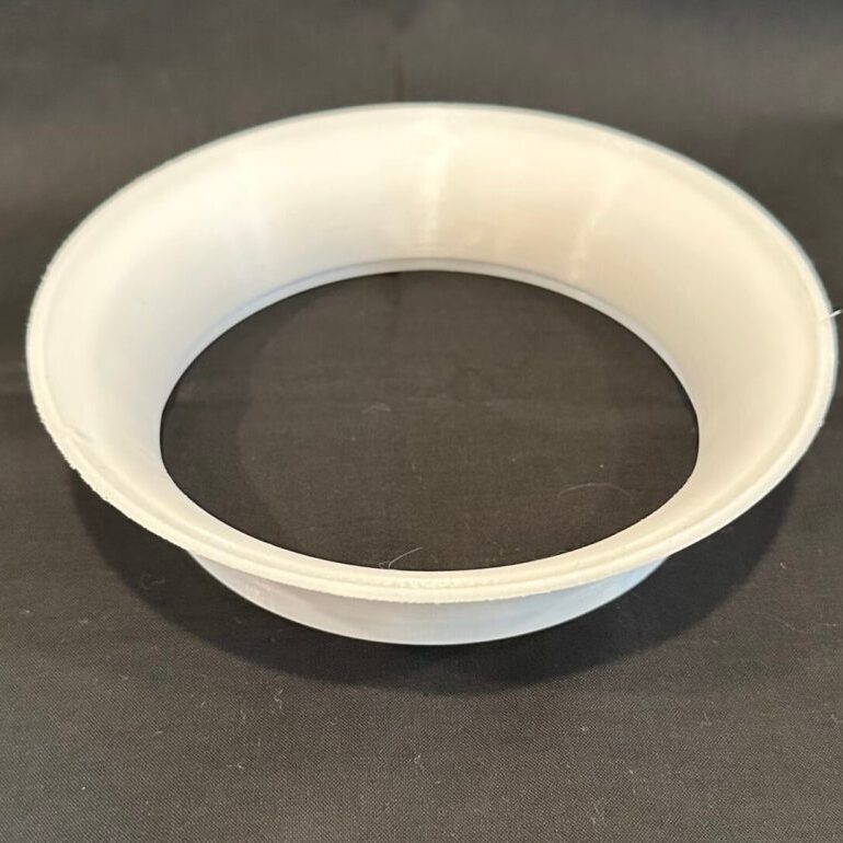 A white bowl sitting on top of a table.