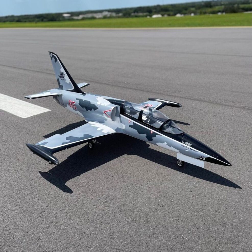 A jet fighter plane sitting on top of an airport runway.